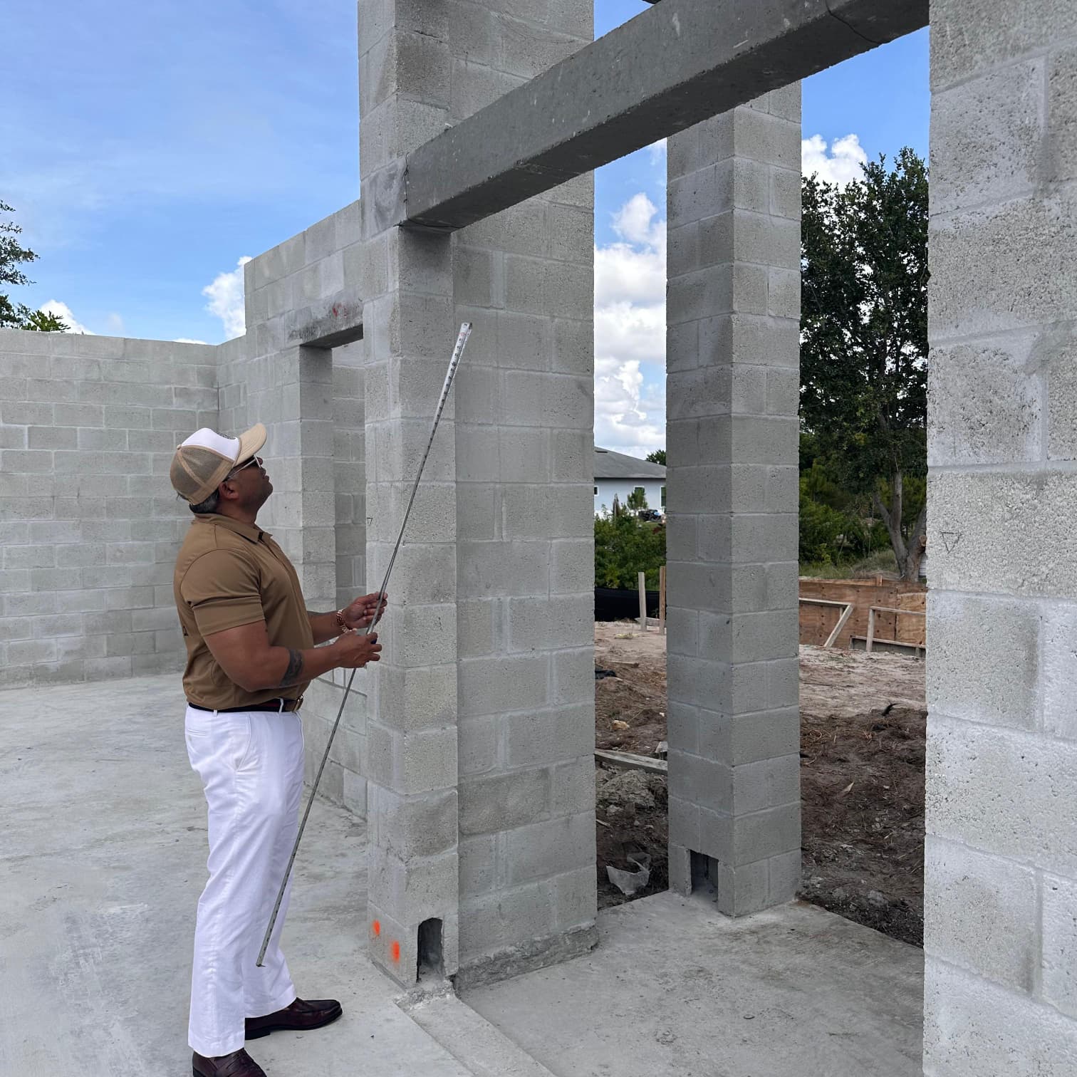 Contractor checking block wall alignment during construction